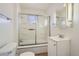 Clean bathroom with a shower-tub combo and a modern vanity with ample storage space at 4835 Harlan St, Wheat Ridge, CO 80033