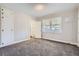 Comfortable bedroom with carpet, a closet, and an en-suite bathroom at 4835 Harlan St, Wheat Ridge, CO 80033