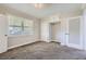 Neutral bedroom featuring plush carpeting, a large window, and integrated closet space at 4835 Harlan St, Wheat Ridge, CO 80033