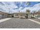 The home is single story with gravel landscaping in the front, plus a carport at 4835 Harlan St, Wheat Ridge, CO 80033