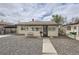 Charming single-story home with a gravel front yard and a cozy bench near the entrance at 4835 Harlan St, Wheat Ridge, CO 80033