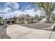 Charming single-story home featuring a covered carport, and a gravel front yard at 4835 Harlan St, Wheat Ridge, CO 80033