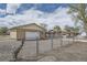 Exterior shot of a detached garage and house, fenced in the yard at 4835 Harlan St, Wheat Ridge, CO 80033