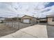 The detached garage is in the rear, behind a chain link fence, next to the covered carport at 4835 Harlan St, Wheat Ridge, CO 80033