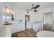 Quaint kitchen featuring white cabinets, a dining area, and a ceiling fan at 4835 Harlan St, Wheat Ridge, CO 80033