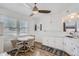 Bright kitchen with white cabinets, wood-look flooring, and a cozy dining area at 4835 Harlan St, Wheat Ridge, CO 80033