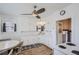 Cozy kitchen with white cabinets, a dining area, and a ceiling fan at 4835 Harlan St, Wheat Ridge, CO 80033