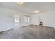 Bright living room with carpet and doorway access to a sunroom, kitchen, and office at 4835 Harlan St, Wheat Ridge, CO 80033