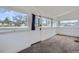 Bright sunroom with large windows and neutral carpet, perfect for relaxation and enjoying the view at 4835 Harlan St, Wheat Ridge, CO 80033