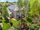 Stunning aerial view of a property with solar panels, a well-maintained lawn, a deck, and surrounded by mature trees at 2019 Clipper Dr, Lafayette, CO 80026