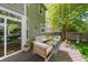 Inviting backyard deck featuring wood furniture, lush greenery, and privacy fence at 2019 Clipper Dr, Lafayette, CO 80026