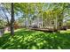 Expansive backyard with lush green grass, a wooden fence, and large deck with outdoor seating is great for gatherings at 2019 Clipper Dr, Lafayette, CO 80026