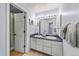 Bathroom features double sinks with lavender countertops and a shower with a decorative curtain at 2019 Clipper Dr, Lafayette, CO 80026