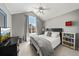 Vaulted ceiling with a large window enhance this bedroom with neutral decor and a mounted TV at 2019 Clipper Dr, Lafayette, CO 80026