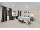 Modern bedroom with neutral tones, gray curtains, and ample natural light at 2019 Clipper Dr, Lafayette, CO 80026