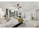 Vaulted ceiling and bay window provide ample light in this bedroom with a TV and decorative rug at 2019 Clipper Dr, Lafayette, CO 80026