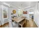 Bright dining room features a farmhouse table, chandelier, large windows, and stylish decor with convenient access to the kitchen at 2019 Clipper Dr, Lafayette, CO 80026