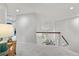 Bright upper hallway overlooking the chandelier-lit living area with wood and white railings at 2019 Clipper Dr, Lafayette, CO 80026