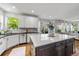 Bright kitchen boasts a center island, stainless steel appliances, and a view into the home's living room and backyard at 2019 Clipper Dr, Lafayette, CO 80026