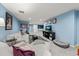 Spacious basement living room with plush seating, a TV, and a pet bed at 2019 Clipper Dr, Lafayette, CO 80026