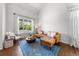 Bright living room with a leather sofa, large window, and hardwood floors offering a cozy seating area at 2019 Clipper Dr, Lafayette, CO 80026