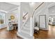 Open staircase leads to the upper level, highlighting the home's seamless flow and showcasing a welcoming glimpse into the dining room at 2019 Clipper Dr, Lafayette, CO 80026