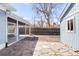 Backyard featuring a covered patio, stone walkways, and a blue painted shed at 1825 S Adams St, Denver, CO 80210