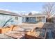 Aerial view of a backyard, with a blue painted house, patio, stone walkway, and garden boxes at 1825 S Adams St, Denver, CO 80210