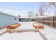 Snowy backyard featuring a shed, garden boxes, and wood fence at 1825 S Adams St, Denver, CO 80210