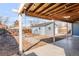 Backyard featuring a covered patio with wood ceiling, string lights, and blue painted shed at 1825 S Adams St, Denver, CO 80210