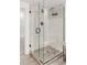 Stylish tiled shower with glass enclosure and bronze fixtures at 1825 S Adams St, Denver, CO 80210