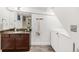 Bathroom with a granite countertop, wood cabinets, and a washer and dryer at 1825 S Adams St, Denver, CO 80210