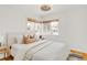 Cozy bedroom features bright windows, neutral decor, and warm hardwood flooring at 1825 S Adams St, Denver, CO 80210