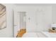 Bright bedroom with hardwood floors, crisp white walls, and convenient ensuite access at 1825 S Adams St, Denver, CO 80210