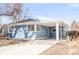 The side of this home features large windows, a carport and a well-maintained yard at 1825 S Adams St, Denver, CO 80210