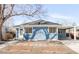 Charming blue home featuring large windows, a carport and a well-maintained front yard at 1825 S Adams St, Denver, CO 80210