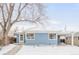 Charming blue single-story home with snow-covered front yard at 1825 S Adams St, Denver, CO 80210