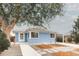 Charming light blue single-story home with mature tree and modern xeriscape front yard at 1825 S Adams St, Denver, CO 80210