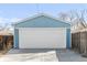 View of a blue one car garage with white garage door and concrete driveway at 1825 S Adams St, Denver, CO 80210