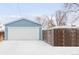 A detached two-car garage showing a crisp white door and matching blue trim at 1825 S Adams St, Denver, CO 80210