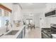 Open kitchen with stainless steel appliances, modern cabinetry, and adjacent breakfast nook at 1825 S Adams St, Denver, CO 80210