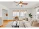 Sunny living room with hardwood floors, built-in shelving, and comfortable seating at 1825 S Adams St, Denver, CO 80210