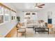 Open-concept living room featuring large windows, hardwood floors, and stylish furnishings at 1825 S Adams St, Denver, CO 80210