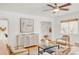 Bright living room featuring hardwood floors, stylish furnishings, and a modern ceiling fan at 1825 S Adams St, Denver, CO 80210