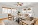 Light-filled living room with hardwood floors, neutral decor, and ceiling fan at 1825 S Adams St, Denver, CO 80210