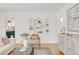 Inviting living room with white walls, hardwood floors, and designer shelving at 1825 S Adams St, Denver, CO 80210