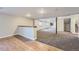 Spacious finished basement with carpet and wood-style flooring at 22436 E Maplewood Pl, Aurora, CO 80015