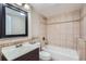 Bathroom featuring tiled walls and a tub-shower combination at 22436 E Maplewood Pl, Aurora, CO 80015