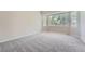 Bright bedroom with plush carpet and a large window for natural light at 22436 E Maplewood Pl, Aurora, CO 80015