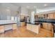 Open kitchen featuring an island, stainless steel appliances, and wood flooring at 22436 E Maplewood Pl, Aurora, CO 80015